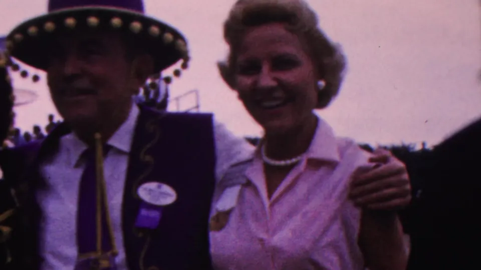 The final frame shows the man in a decorated hat and purple vest between two smiling adult women, one partly behind him and one in a light blouse with pearls, at a likely public event in Indiana in 1963.