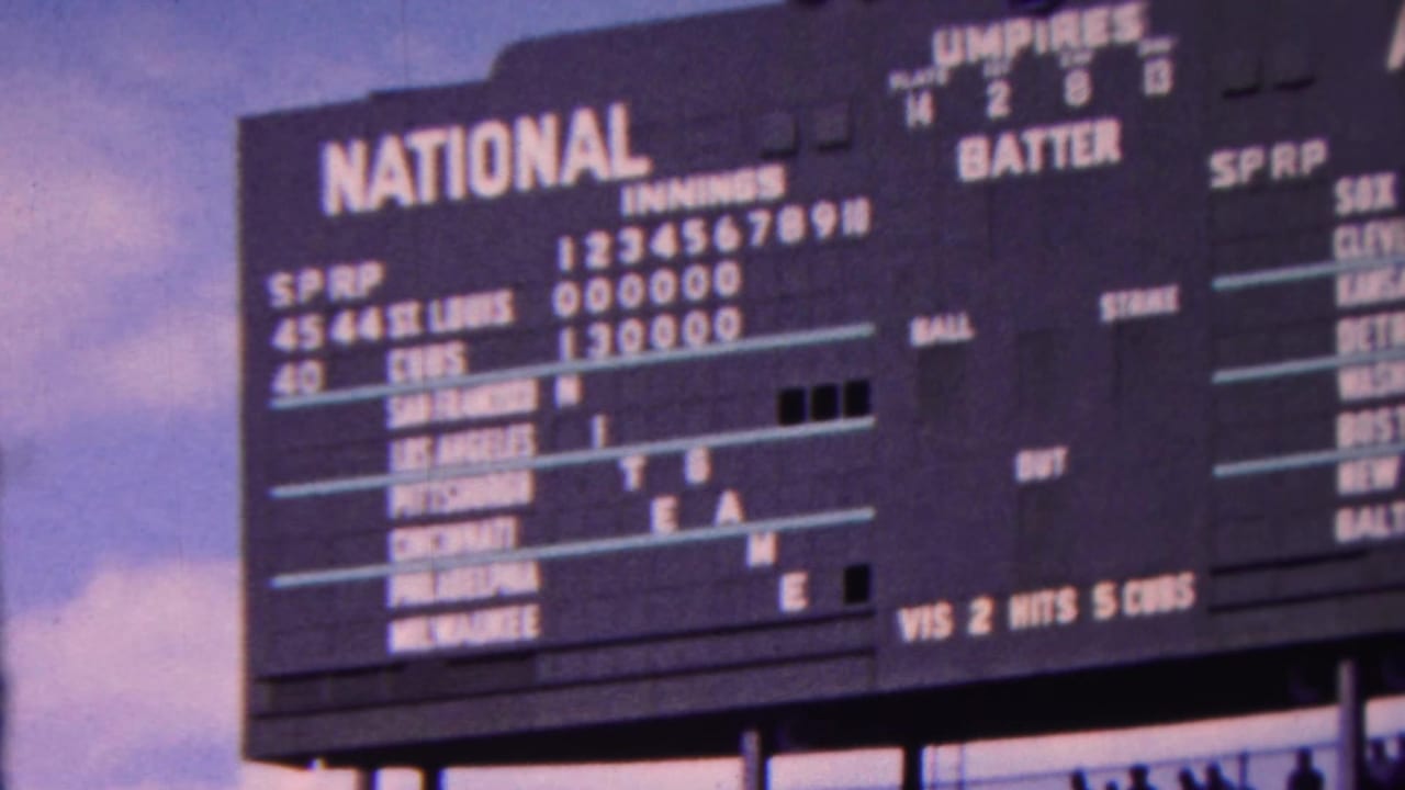National League scoreboard showing St. Louis and Chicago lines against a blue sky.