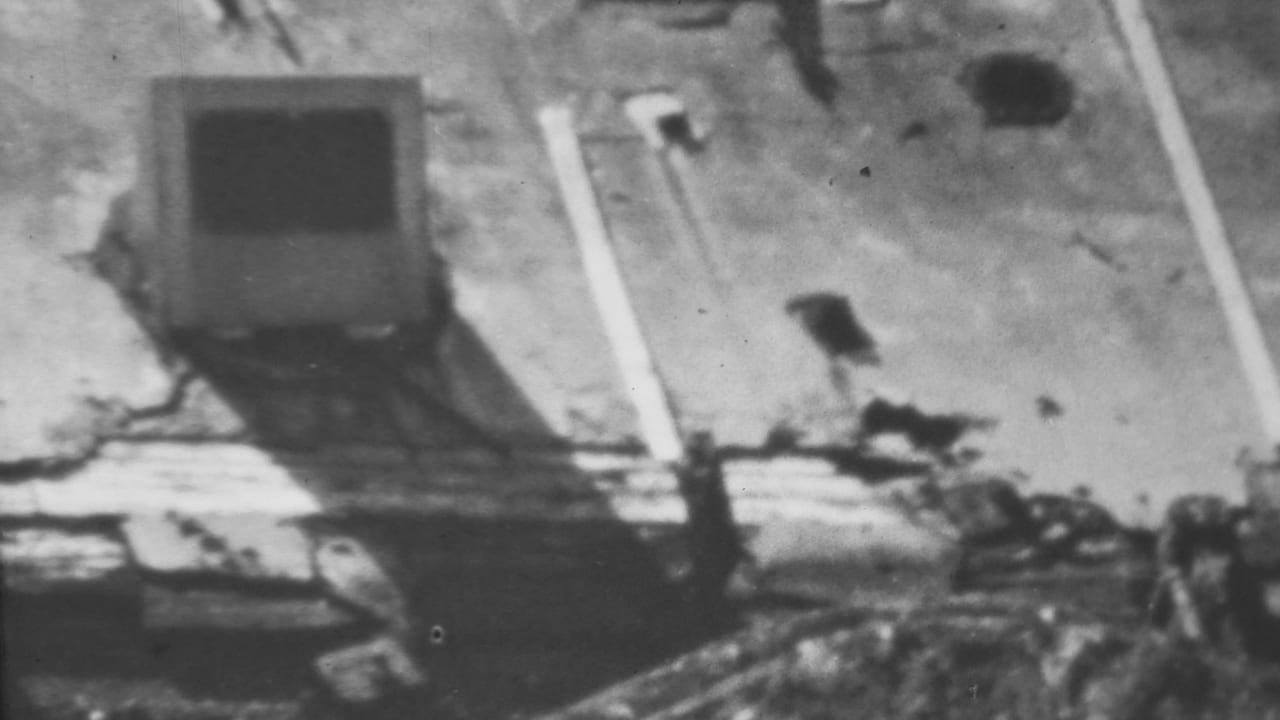1962 Honolulu/Pearl Harbor-area 8mm frame showing a damaged small structure amid floodwater, scattered debris, and high-contrast shadows.