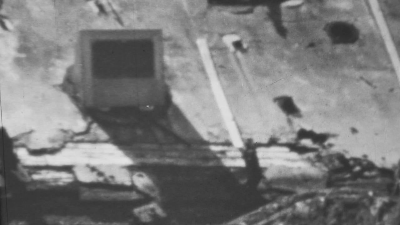 1962 Honolulu/Pearl Harbor-area black-and-white frame with a damaged structure, floodwater, debris piles, and a bright diagonal beam or pipe.