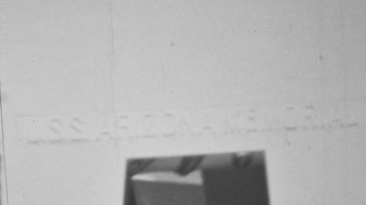 1962 Pearl Harbor-area home-movie frame showing a partially visible arched interior with a dark opening and strong overexposed wall area.