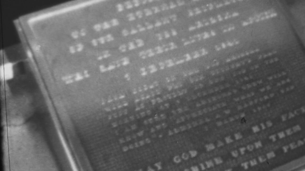 Soft monochrome 8mm close-up of a weathered engraved religious plaque in Pearl Harbor, Hawaii, based on the supplied 1962 clip metadata.