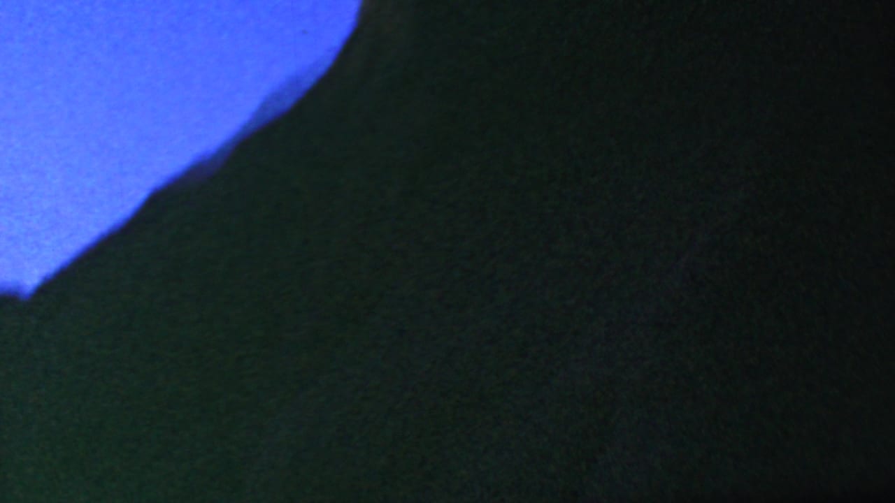Large dark rounded silhouette against blue sky.