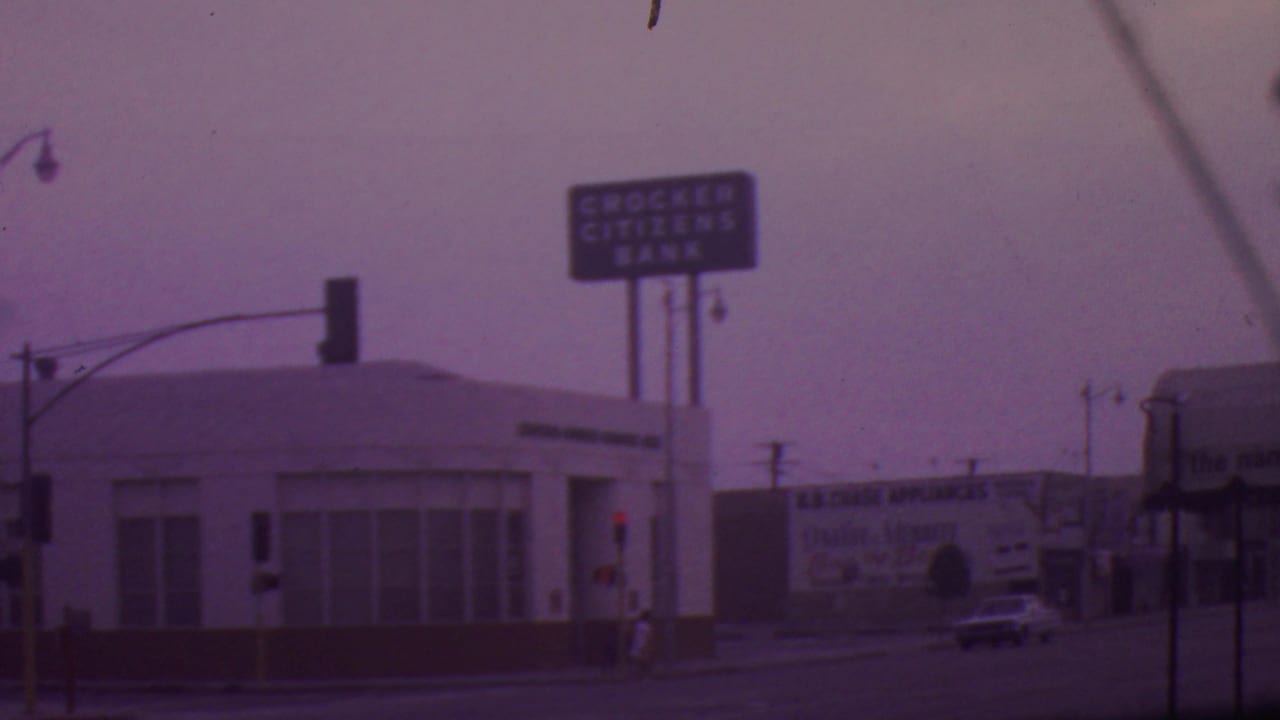 Los Angeles intersection view with the Crocker Citizens Bank sign, a B.B. Chase Appliances billboard, traffic signals, and mid-1960s cars on the street.