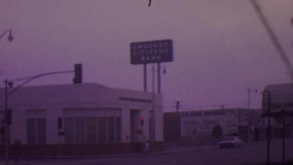 Los Angeles intersection view with the Crocker Citizens Bank sign, a B.B. Chase Appliances billboard, traffic signals, and mid-1960s cars on the street.