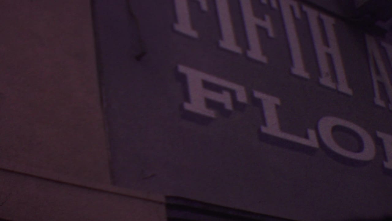 1965 Los Angeles 8mm close-up showing cropped large letters from the Fifth Avenue Florist storefront signage on a flat facade.