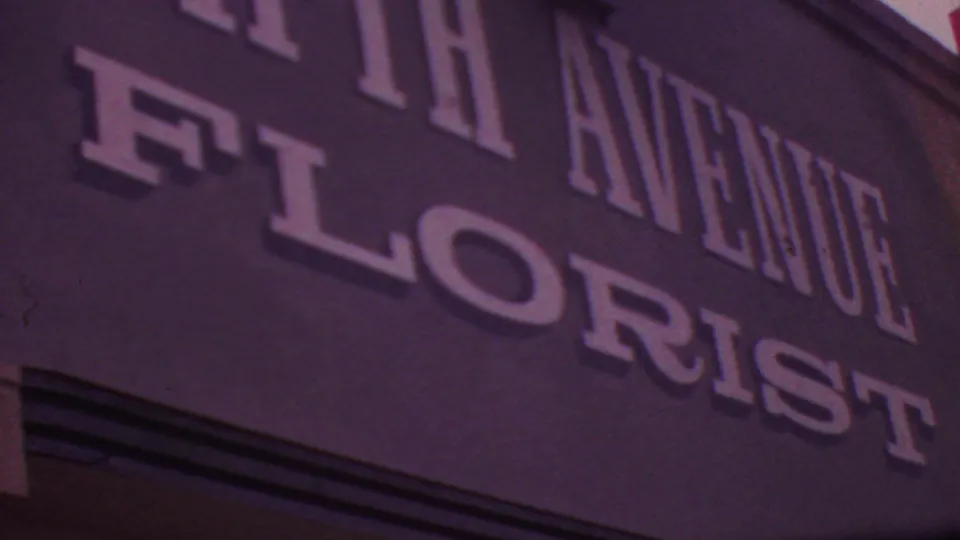 Angled 1965 Los Angeles view of the FIFTH AVENUE FLORIST sign, cropped tightly across the raised white letters and dark facade.