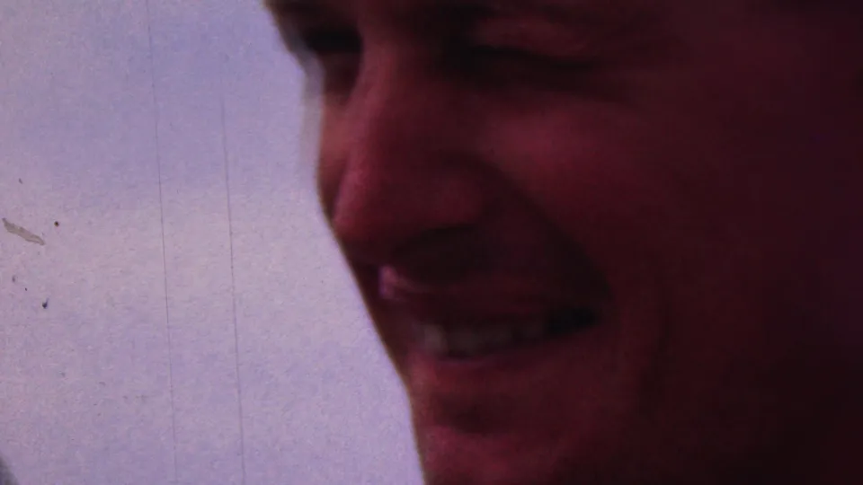 Close-up 1953 8mm home-movie frame of a smiling adult man, with soft focus, saturated color, and visible film marks; the Cleveland, Ohio attribution comes from clip metadata.