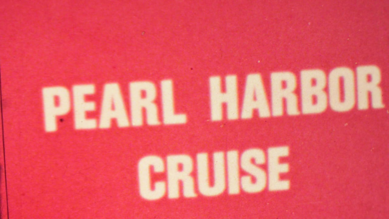 Red-toned 8mm frame showing a Pearl Harbor Cruise sign with large white block letters in Hawaii footage dated 1962 by metadata.