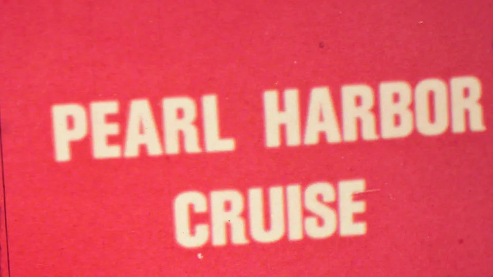 Cropped 1960s Hawaii home-movie frame showing the Pearl Harbor Cruise sign with large white lettering and visible 8mm wear.
