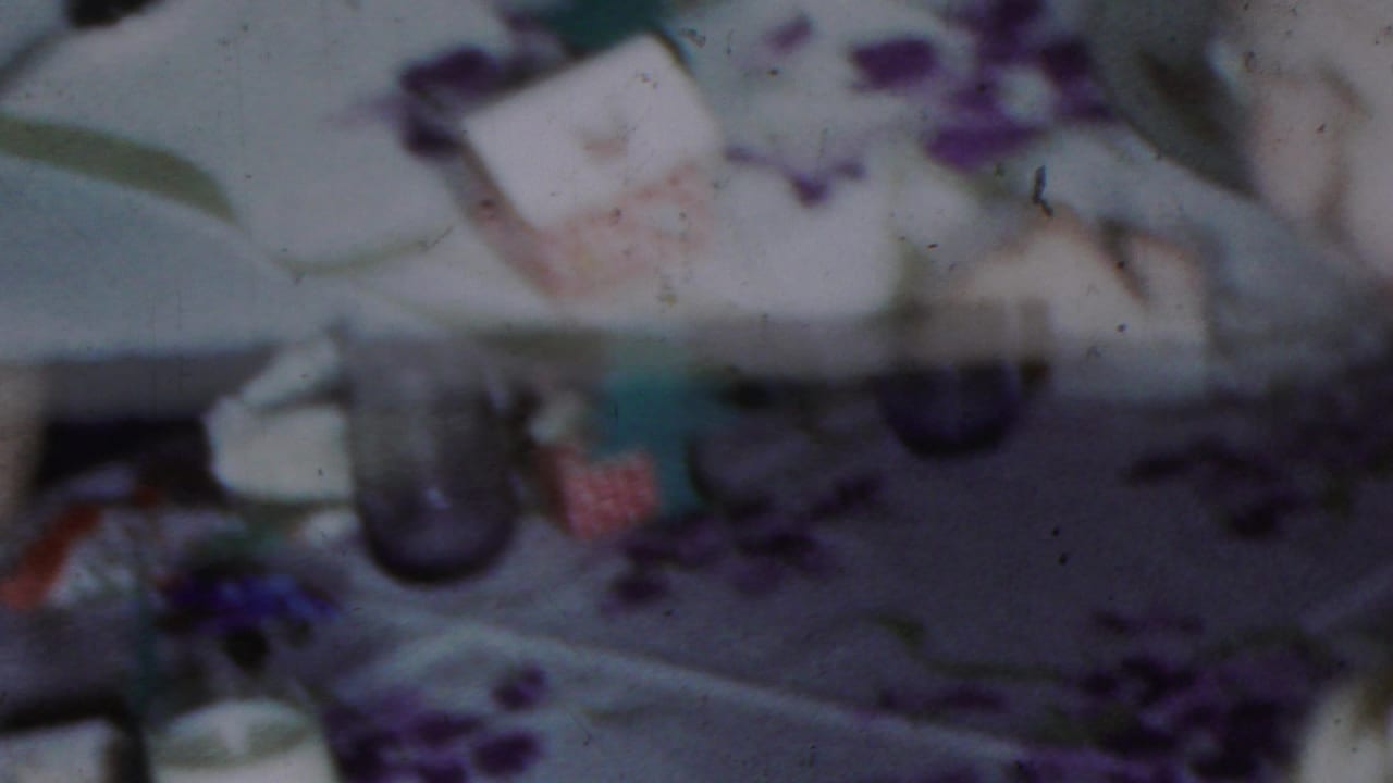 Out-of-focus patterned material with pale background and purple shapes.