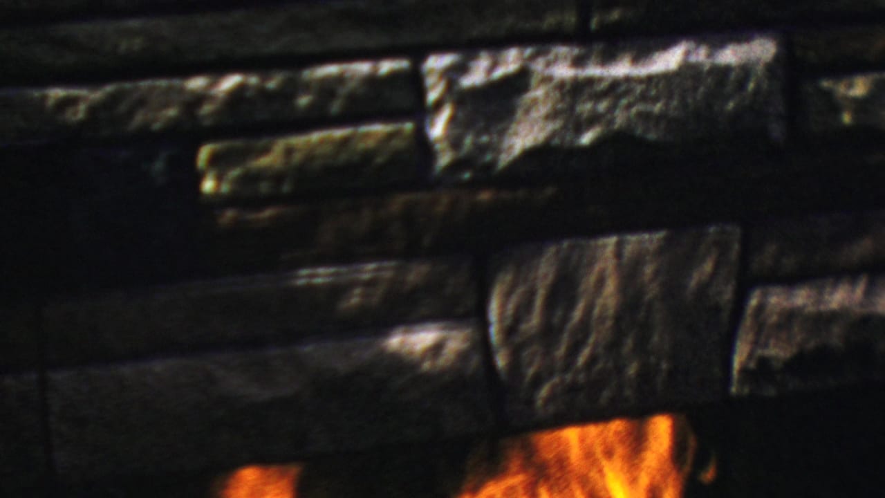 Dark stone fireplace surround with flames visible near the bottom edge.