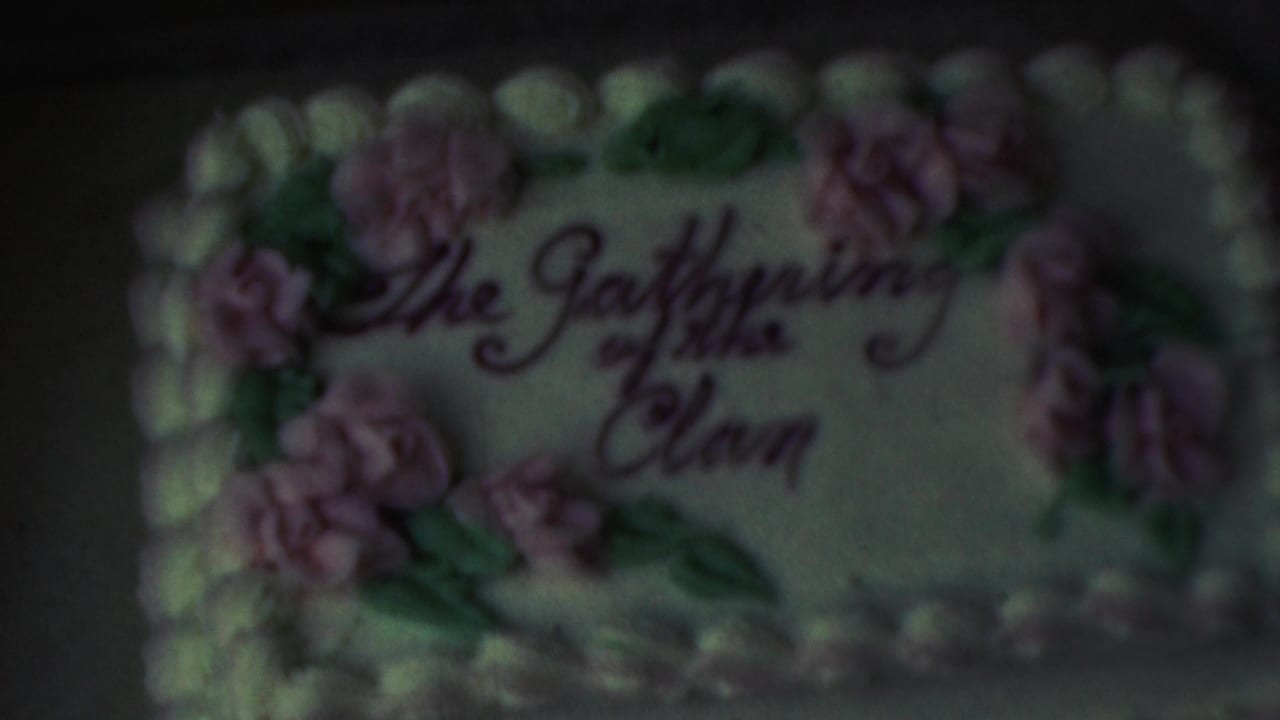 Soft close-up of the same decorated cake with cursive writing and floral icing.