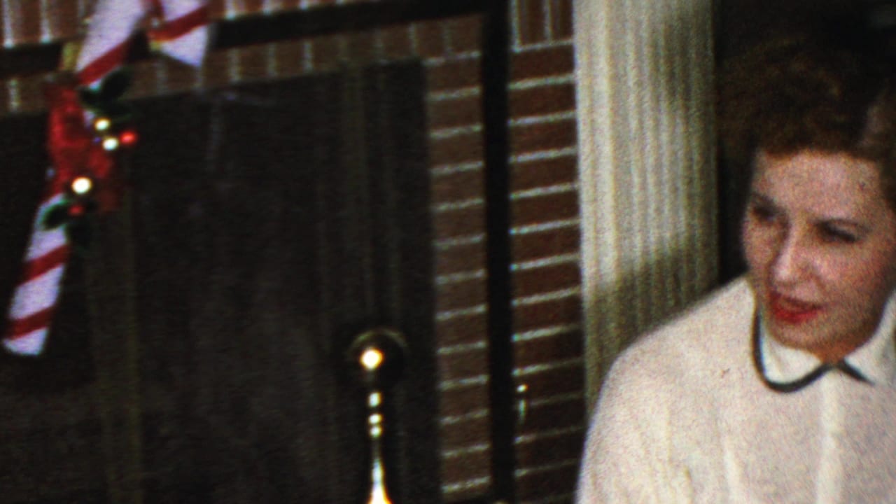 Woman partly visible beside a decorated brick fireplace.