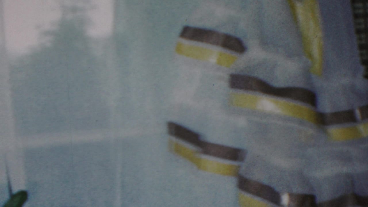 Softly blurred 1949 Seaside, New Jersey home-movie frame of a striped curtain and pale interior surface inside the same private domestic setting.