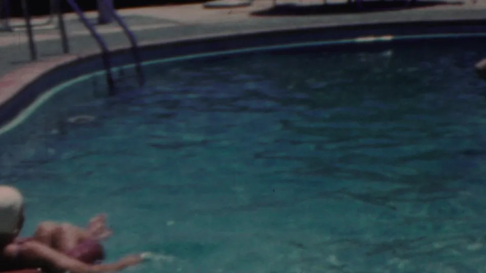 1949 Seaside, New Jersey 8mm frame with a woman in a white swim cap partly visible at the lower edge as the pool surface fills most of the view.