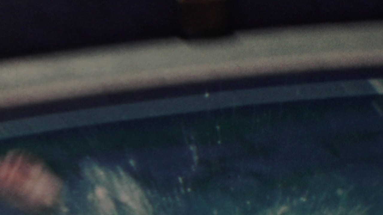 Blurred swimmer enters the water near the edge as a splash begins.