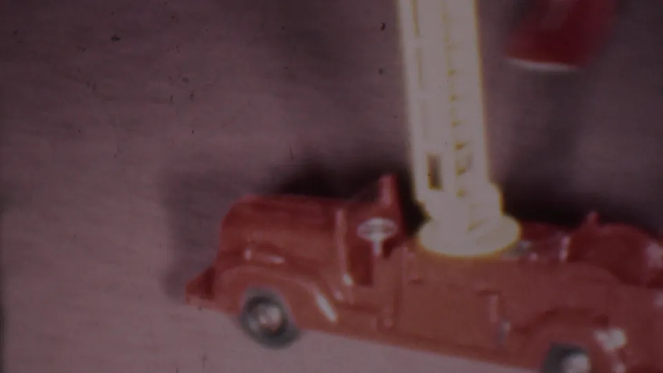 Side view of the red toy fire engine with an upright yellow ladder in the 1956 Phoenix holiday home-movie footage.