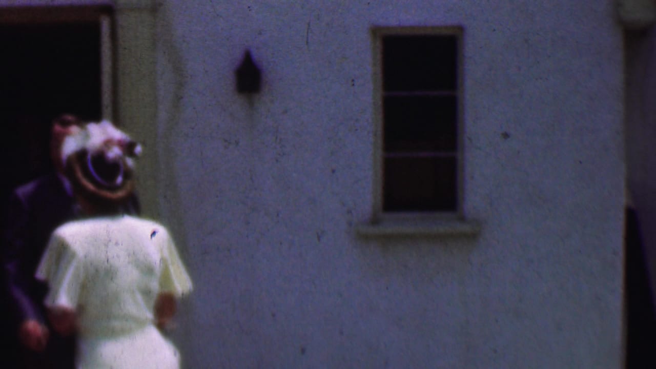 Woman in white stands near a man in a dark suit outside the church entrance.