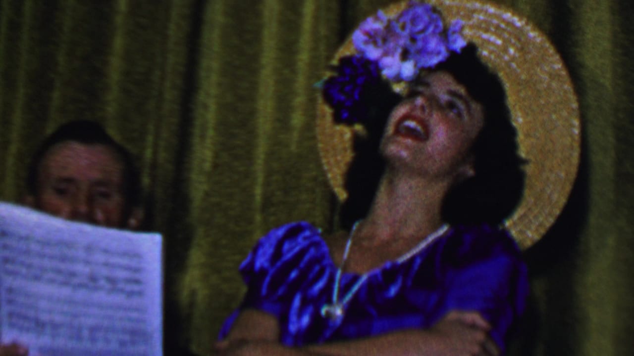 Singer in a blue dress and floral straw hat tilts her head beside visible sheet music.