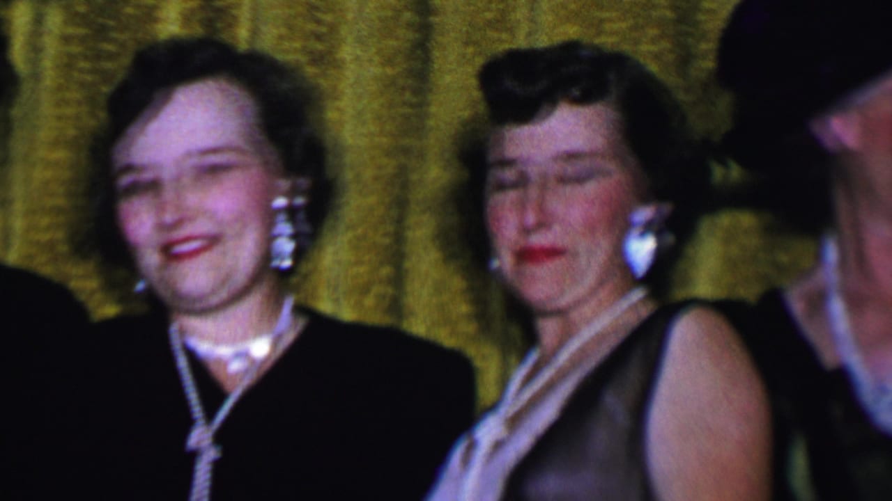 Women stand close together as one person is partly cropped at the edge.