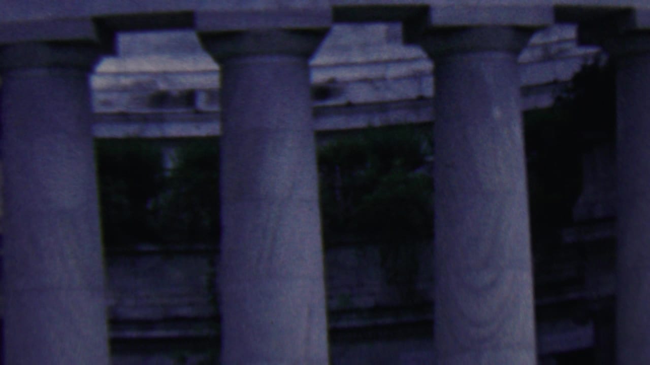 Close view of large stone columns and architectural trim.