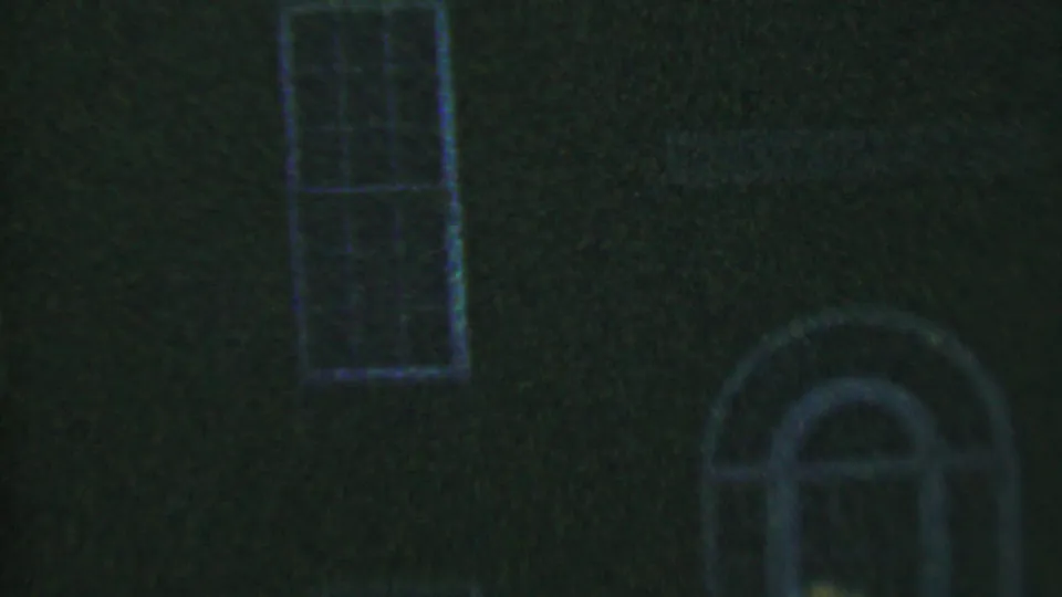 Low-light 8mm frame showing a tall rectangular window and a partial arched window on a dark brick house exterior in Hatfield, Pennsylvania.