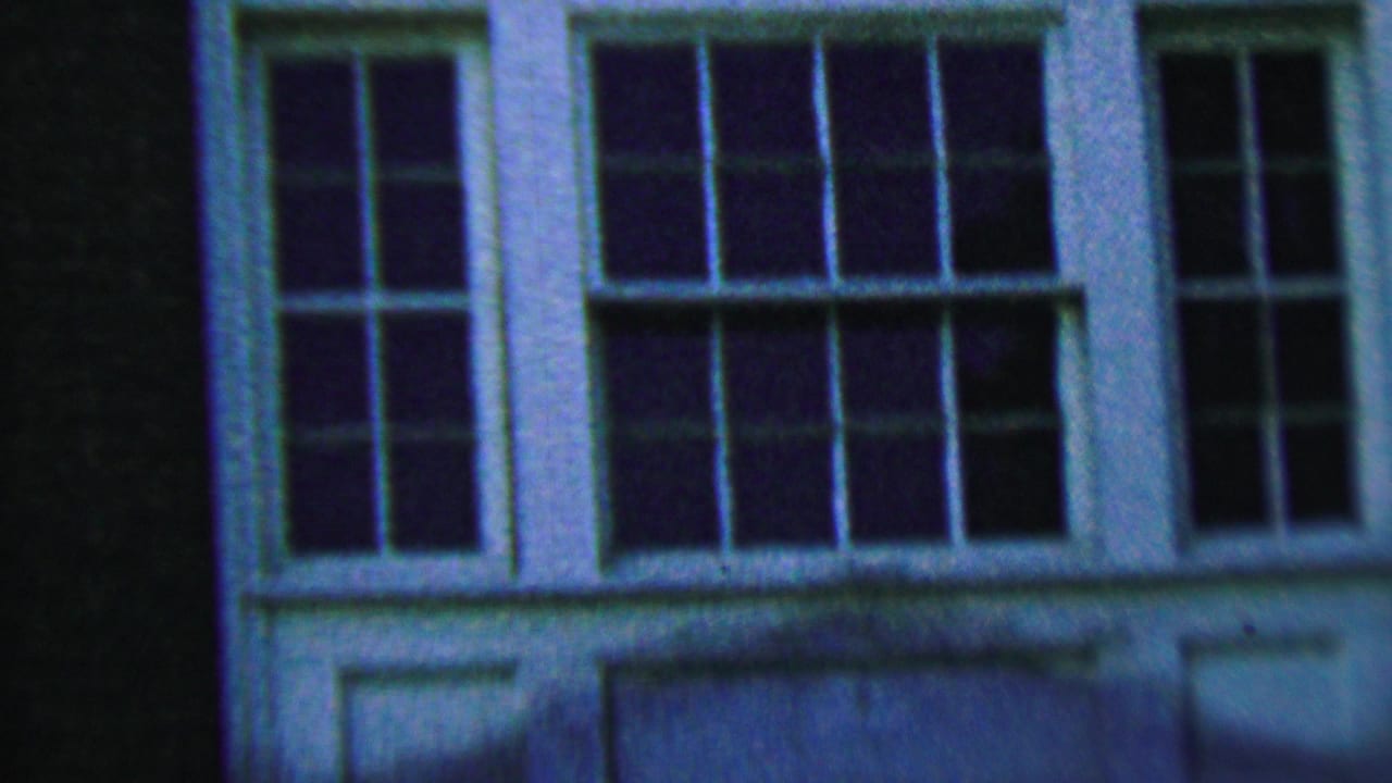 White multi-pane window set in a dark exterior wall.