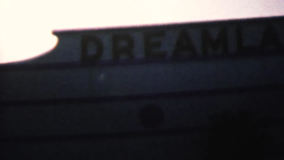 Partial Dreamland sign lettering appears along a roofline or marquee against a bright sky in Hatfield, Pennsylvania footage from 1956.