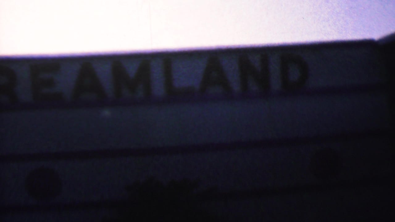 Close view of Dreamland letters on a shadowed sign or marquee.