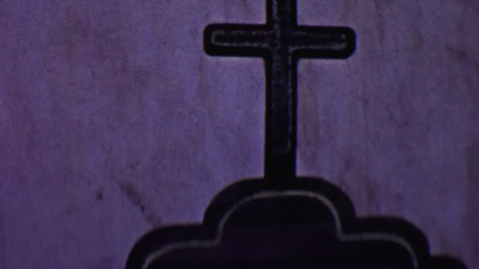 Close 8mm view in Solvang showing the cross and upper shape of the marker before the camera tilt reveals the inscription below.
