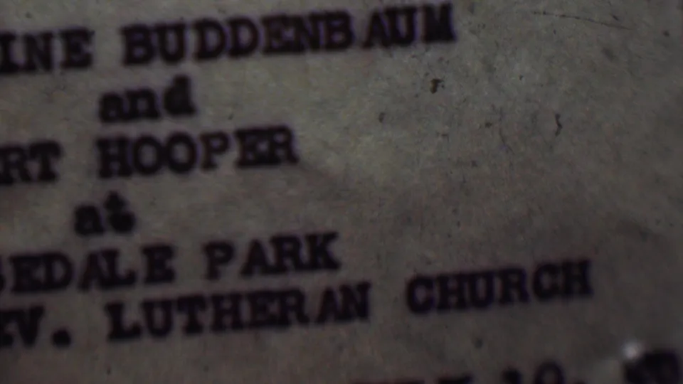 Soft 8mm frame of the typewritten invitation text, with Hooper and Edale Park Lutheran Church partly legible across aged paper.