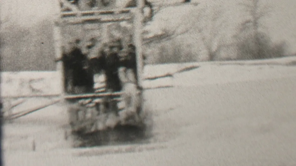 A lightly dressed figure appears near bundled spectators on the wooden platform, consistent with the described polar bear plunge setting in Albany, New York, 1937.