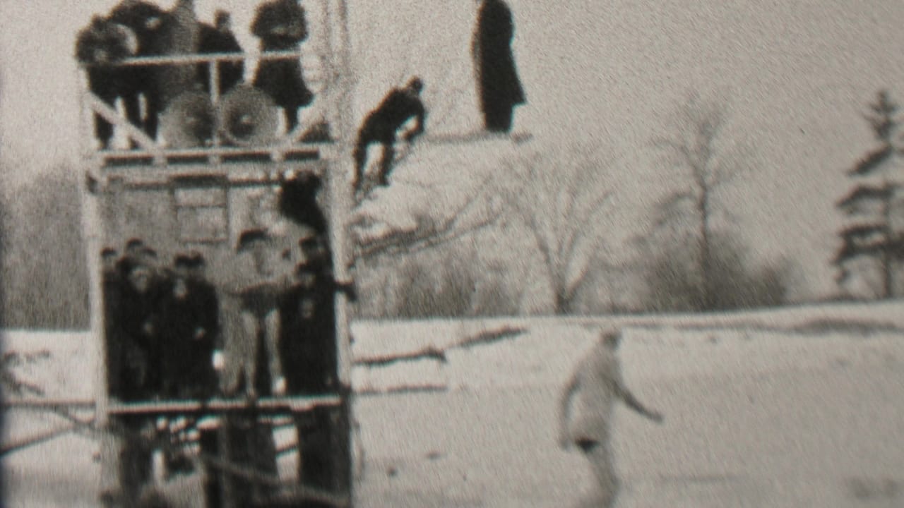 In Albany, New York, 1937 home-movie footage, people in long coats gather on a wooden viewing platform as one figure climbs up beside the snowy ice.
