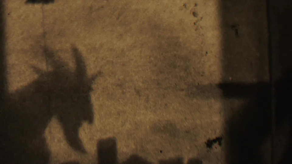 The final frame shifts to a dark, brown-toned transitional view with an indistinct shadow-like form, likely part of the film's end or a scene change rather than a clear subject.