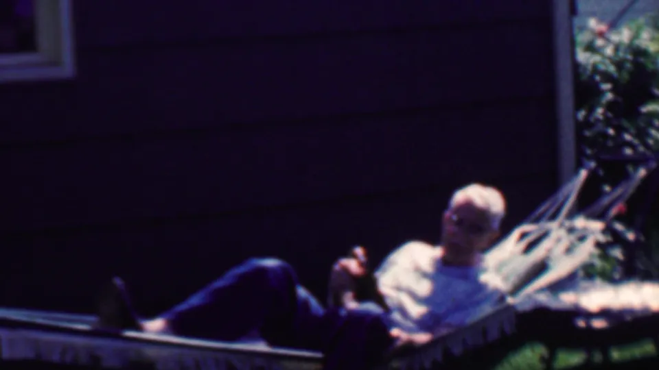 The final frame shows the adult man more upright in the backyard hammock, gesturing toward the camera against dark house siding and green lawn.