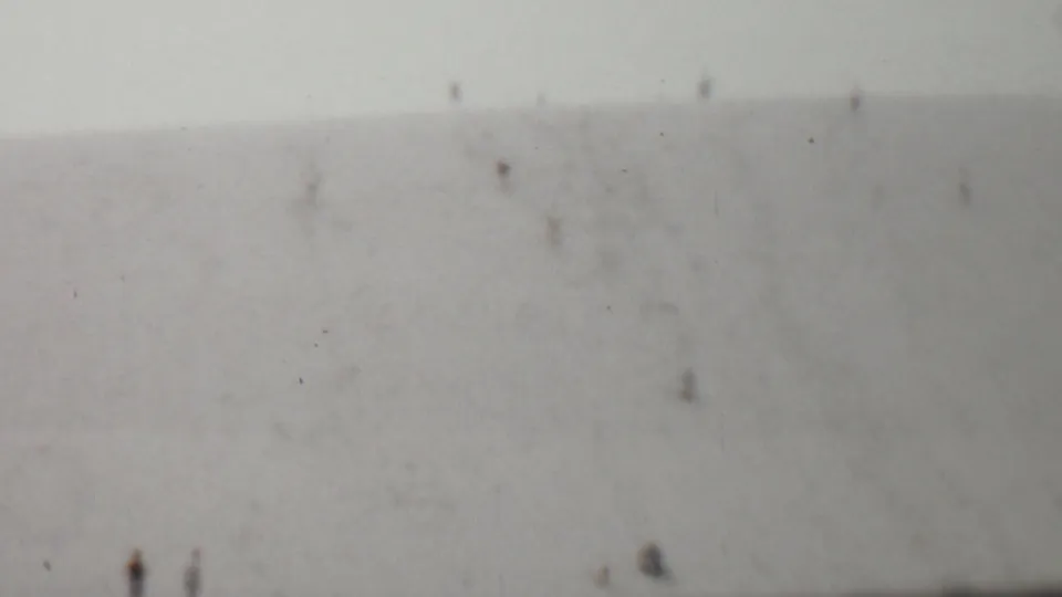 Distant figures are visible near the lower portion of the hillside in this soft 1959 United States 8mm home-movie frame.