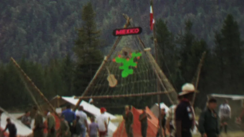 1967 Farragut State Park festival scene with a Mexico sign, cactus decoration, Mexican flag, tents, and visitors crossing a grassy field.