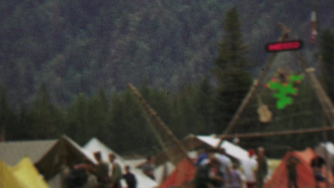 Similar festival display with a Mexico sign, tents, and visitors in a grassy area.
