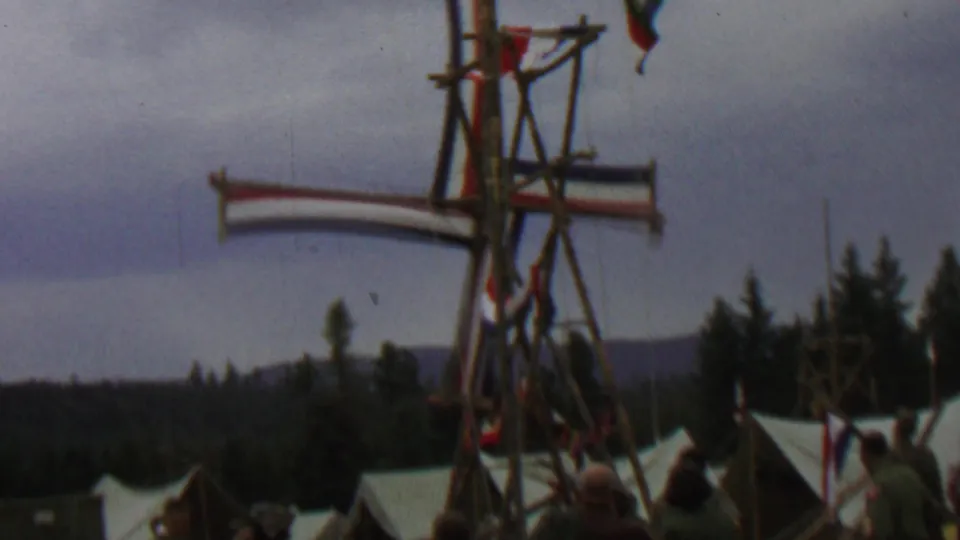 1967 Farragut State Park frame showing part of the Dutch-style wooden windmill, a red, white, and blue striped sail, white tents, evergreens, and distant hills.