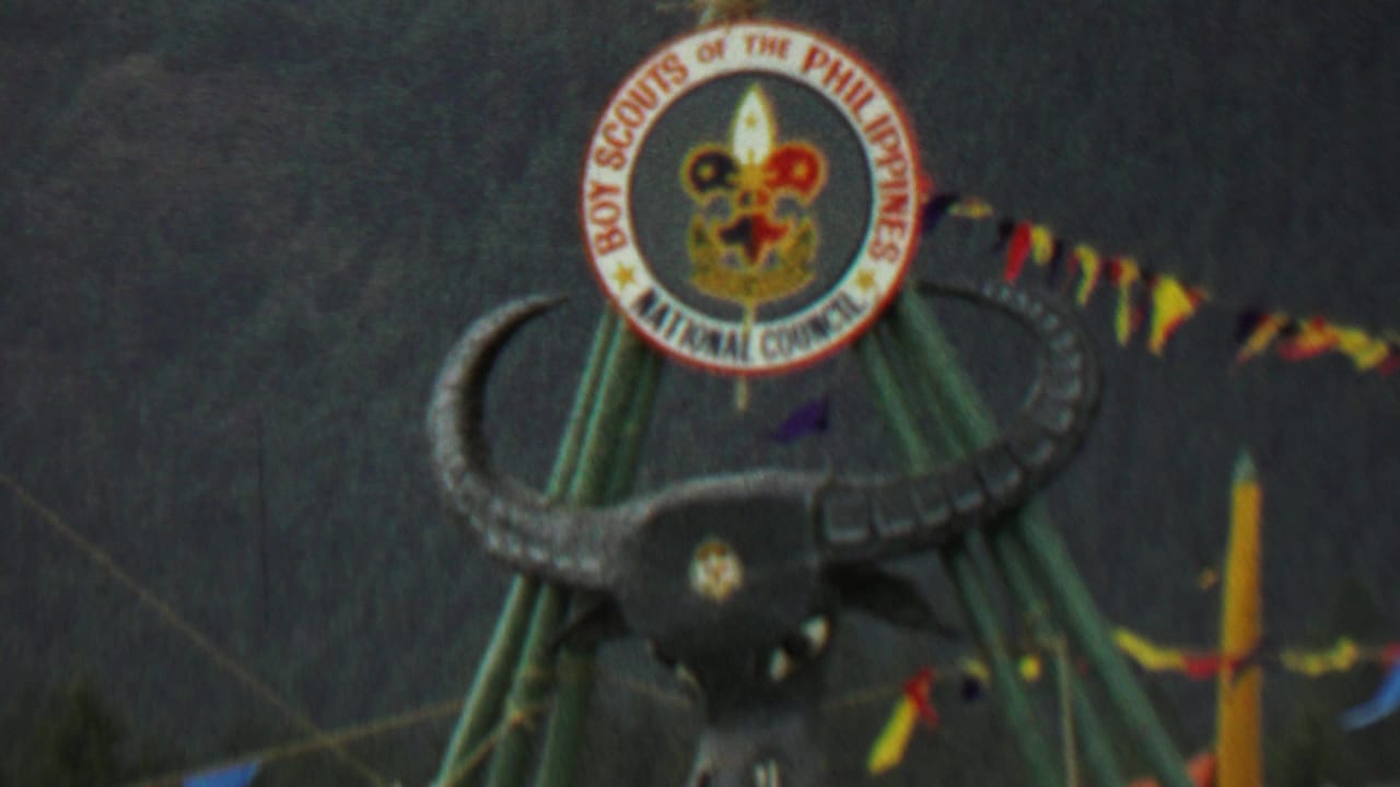 Close 1967 Farragut State Park frame showing the circular Boy Scouts of the Philippines National Council emblem above a stylized bull's head on green poles, with pennant flags crossing the background.