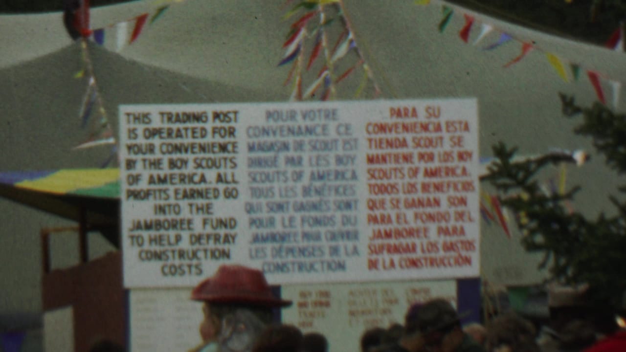 Trading post sign repeated from a slightly shifted angle with pennants overhead.