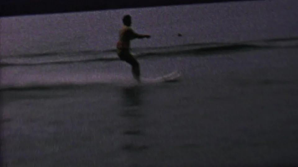 In 1962 home-movie footage identified as St. Paul, Minnesota, a woman appears to water ski behind a motorboat on a lake, with the tow rope stretching across the water.