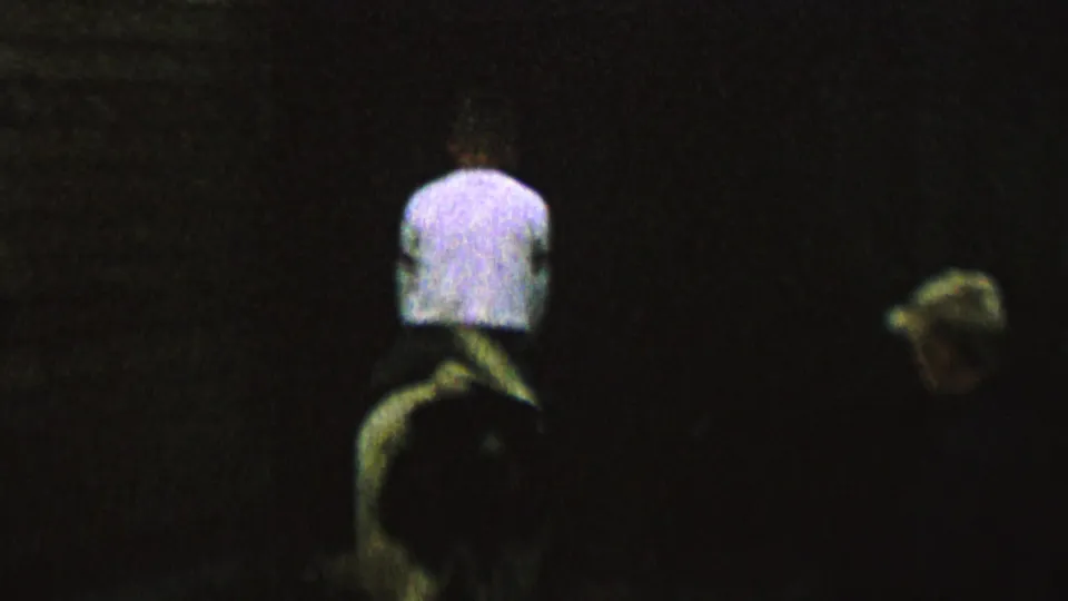 The final frame shows the rider and cow farther into the dark scene, with the rider centered and the cow's lighter head or body shape visible to the right.