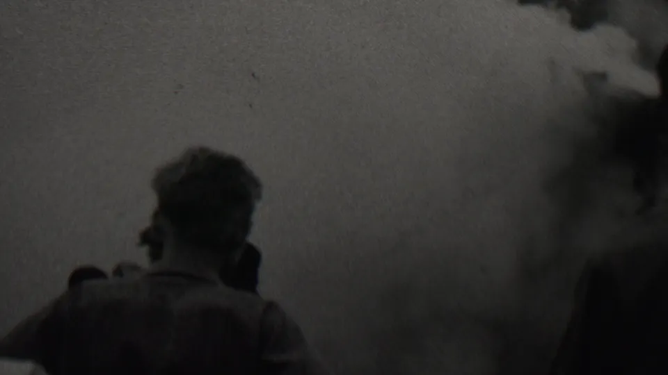 In 1937 Trenton, New Jersey metadata, silhouetted men stand with their backs to the camera while dense smoke or fumes spread across the frame.