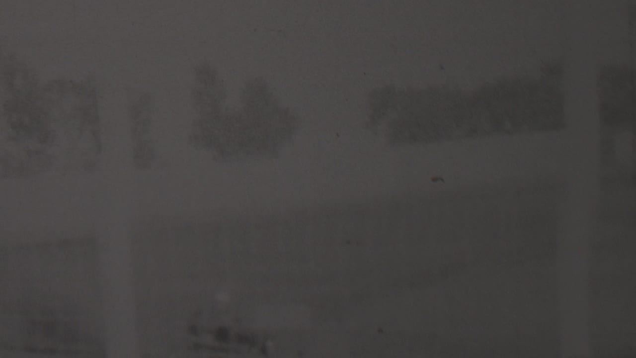 Obscured track view with blurred dark shapes near the upper frame.
