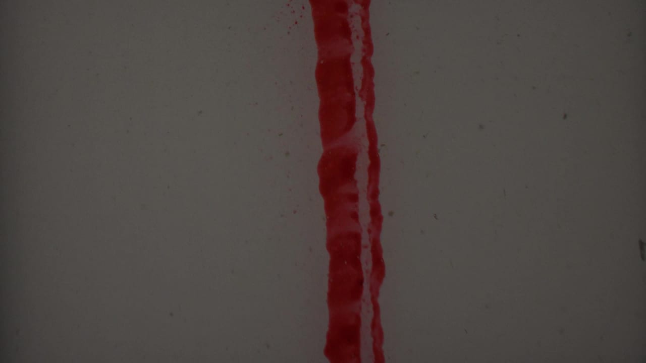 Tall red vertical streak beside partial red marks on a pale gray background.