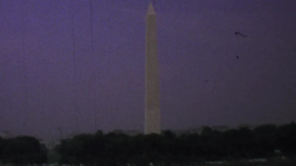End frame of the 1969 Washington, D.C. home movie clip, with the Washington Monument near the right side against a dusky purple sky.