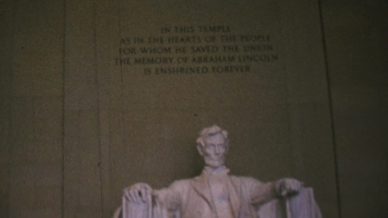 1969 8mm view inside the Lincoln Memorial in Washington, DC, with the seated Lincoln statue partly low in frame below the chamber inscription.