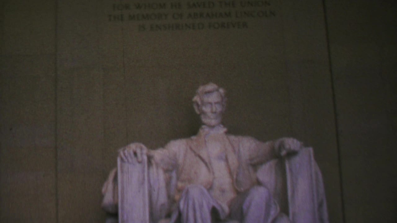 Seated Lincoln statue centered below the upper memorial wall.